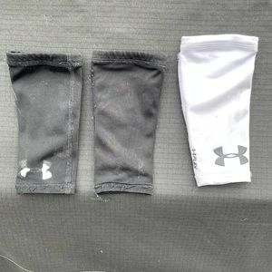 YS UnderArmour forearm pads for football. 2 black and one white.